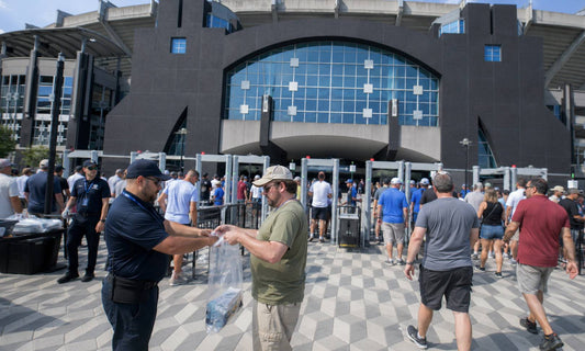 Fans lined up for bag check at a Bank of America Stadium gate