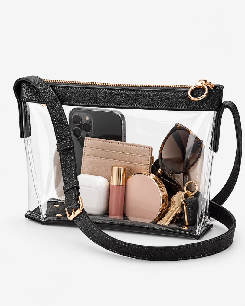 Black clear purse packed with a large smartphone, a card wallet, sunglasses, an earbuds case, a lip gloss, a compact and keys