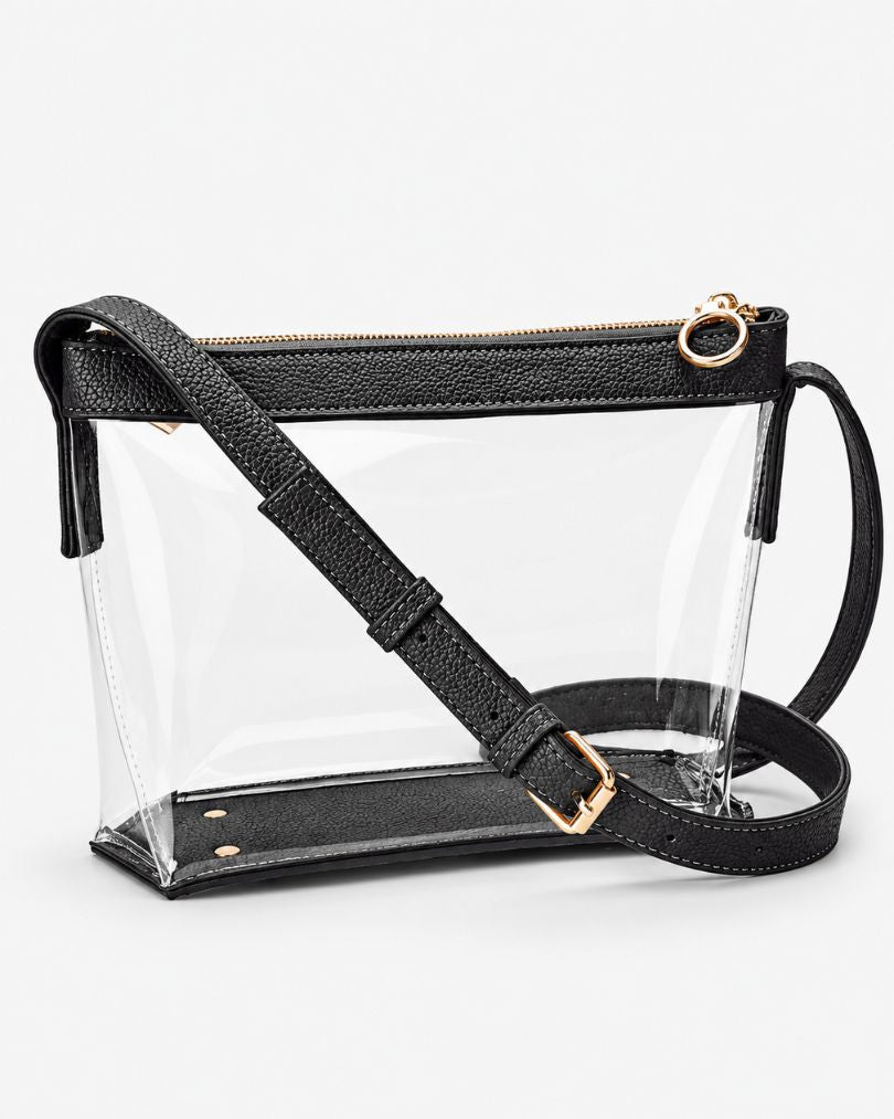 Black clear purse with vegan leather trim and an adjustable strap, empty, in a three-quarter side view on a white background