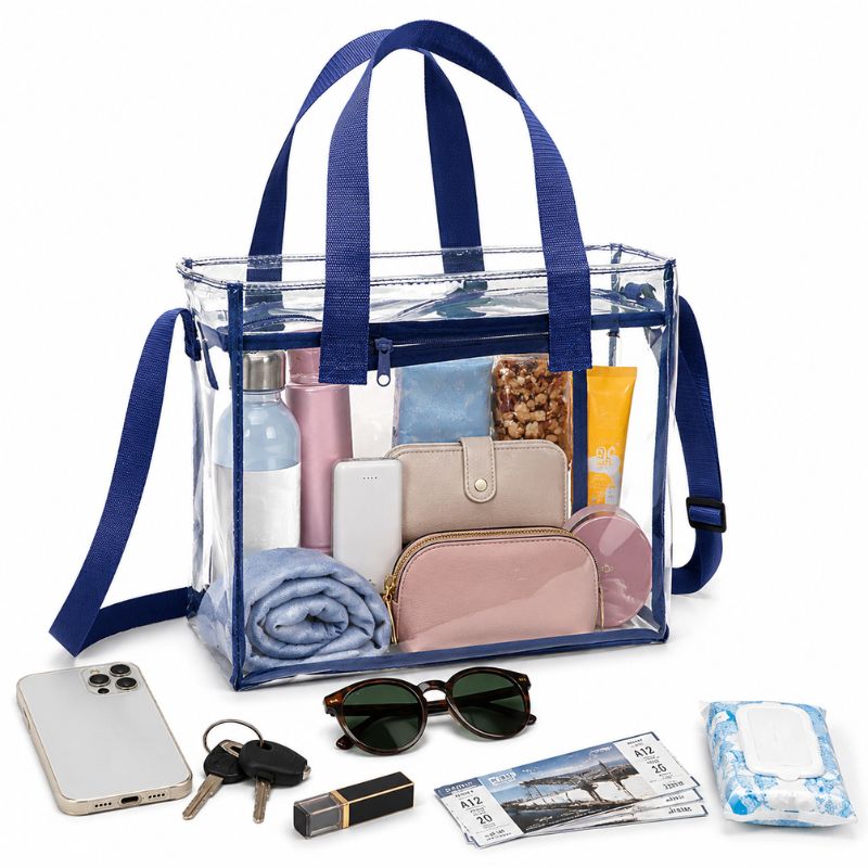 Navy-trim clear crossbody tote packed with a water bottle, wallet, phone, pouch and other event essentials.