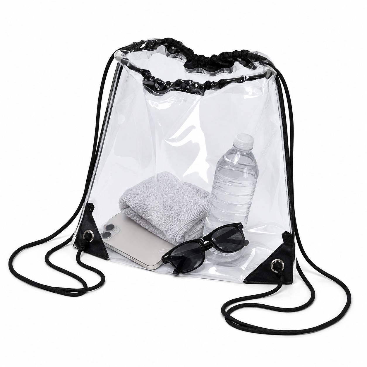 Clear drawstring backpack bag packed with a towel, water bottle, phone, and sunglasses, shown at an angle.