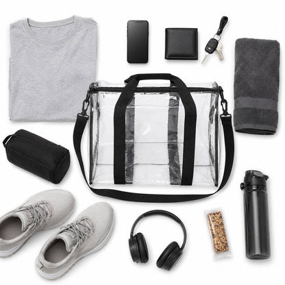 Top-down flatlay of the clear duffel bag surrounded by a shirt, phone, wallet, keys, towel, toiletry bag, shoes, headphones, and a water bottle.