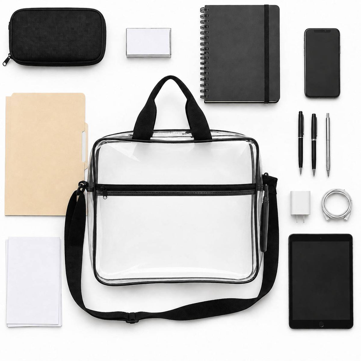 Top-down flatlay of the clear portfolio briefcase surrounded by a pouch, business cards, a notebook, phone, pens, charger, and tablet.