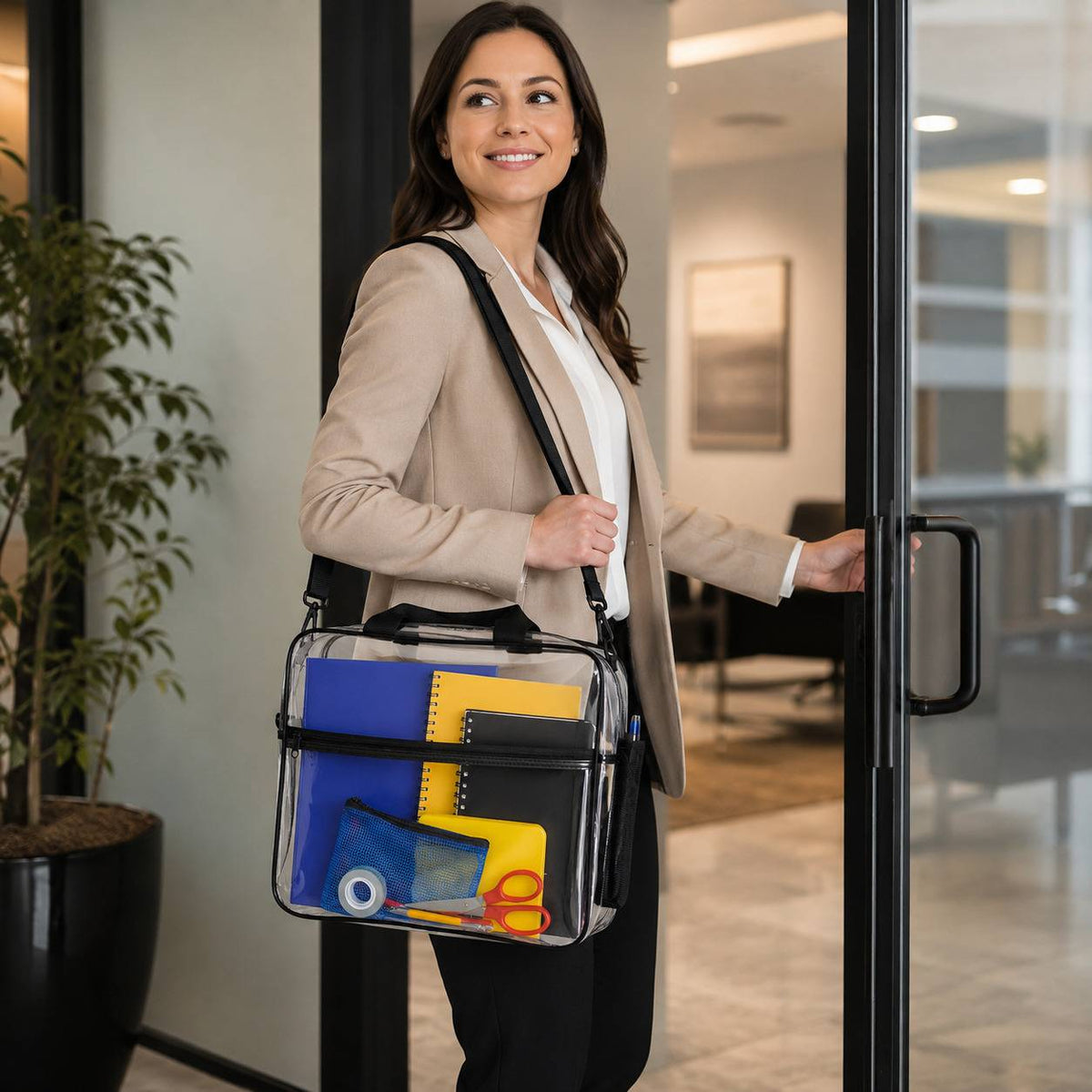 Woman carrying the clear portfolio briefcase packed with folders while opening an office door.