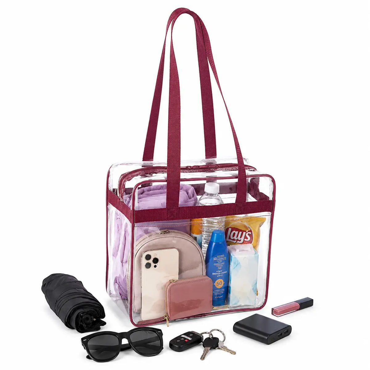 Clear stadium tote bag in burgundy trim shown packed to demonstrate capacity
