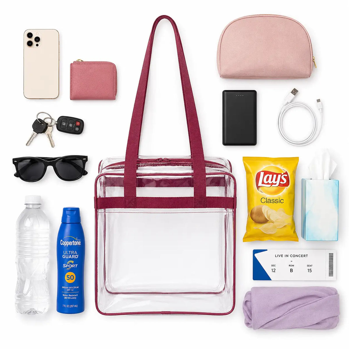 Flat lay of a clear stadium tote bag with burgundy trim showing interior capacity