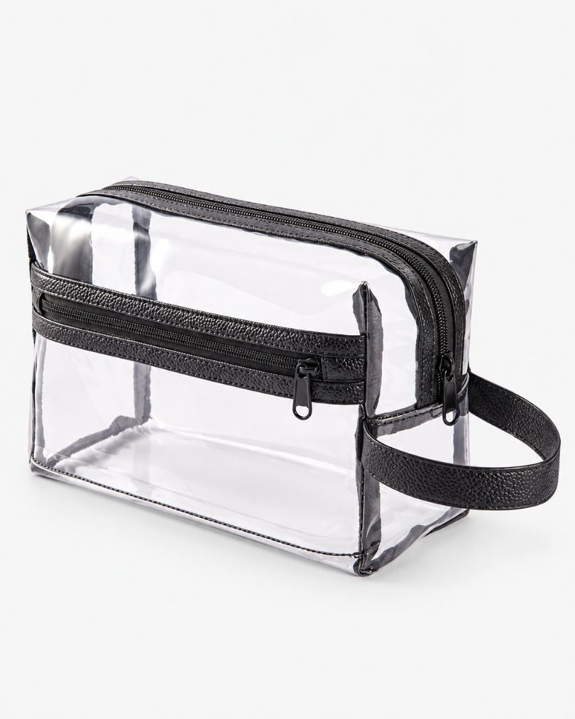 Medium clear toiletry bag with black trim, top zipper, front zip pocket and carry handle, shown empty on a white background.