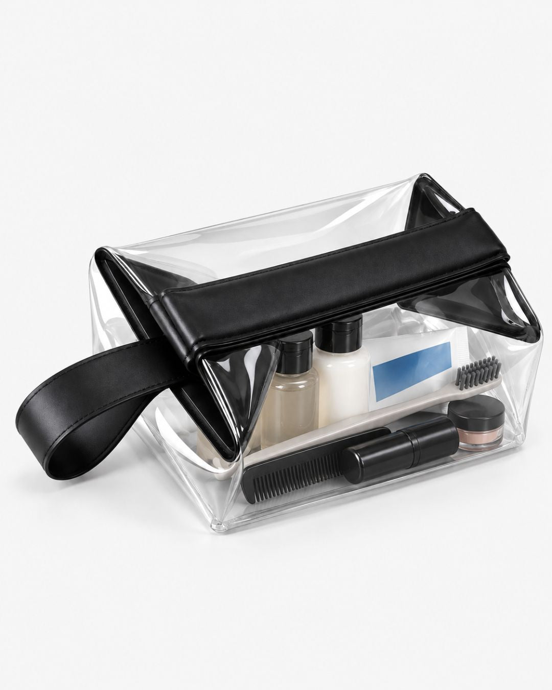 Clear toiletry bag packed with travel bottles, a lotion tube, toothbrush and comb, with the fold-over closure open to show the contents.