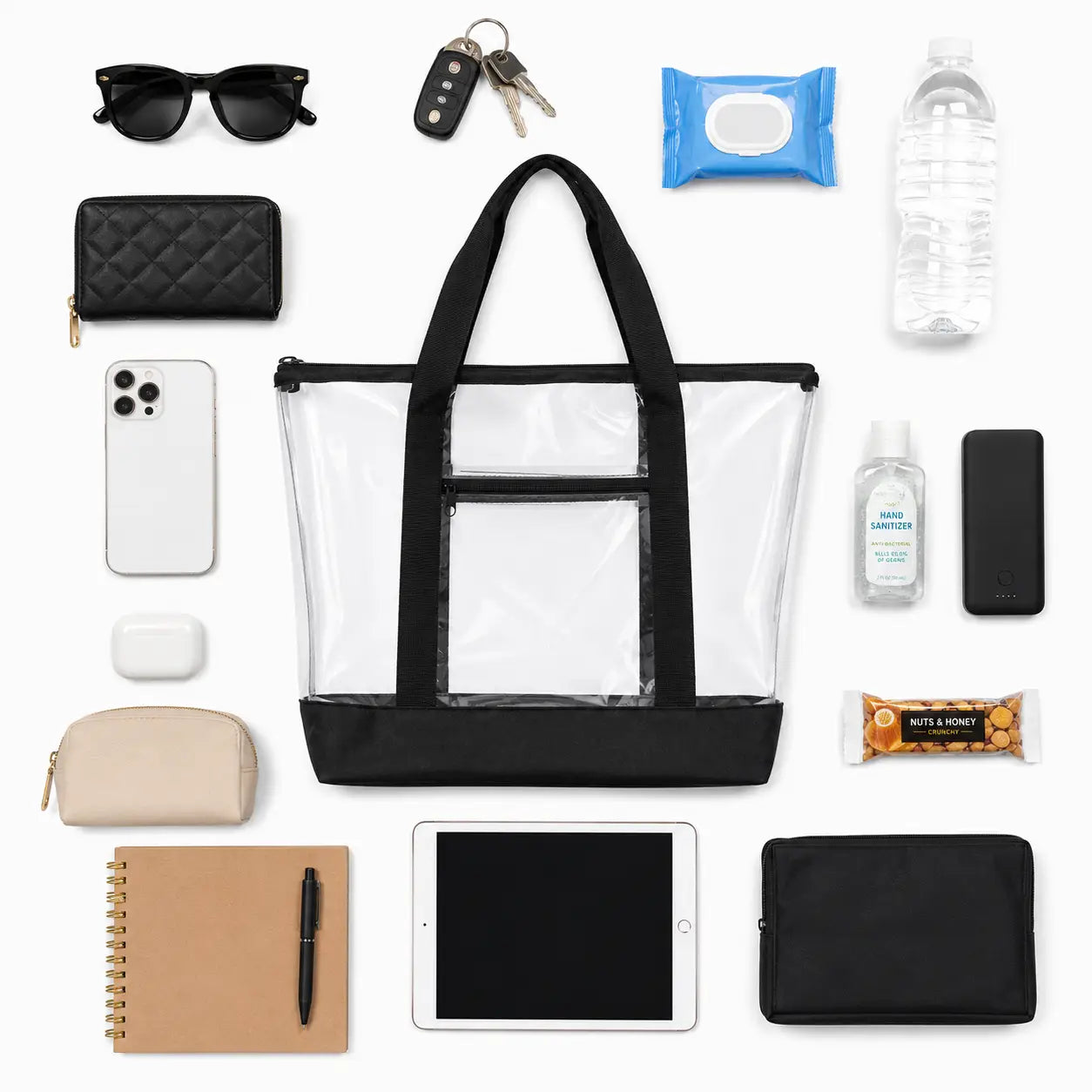 Clear tote bag laid flat beside sunglasses, phone, water bottle and daily essentials