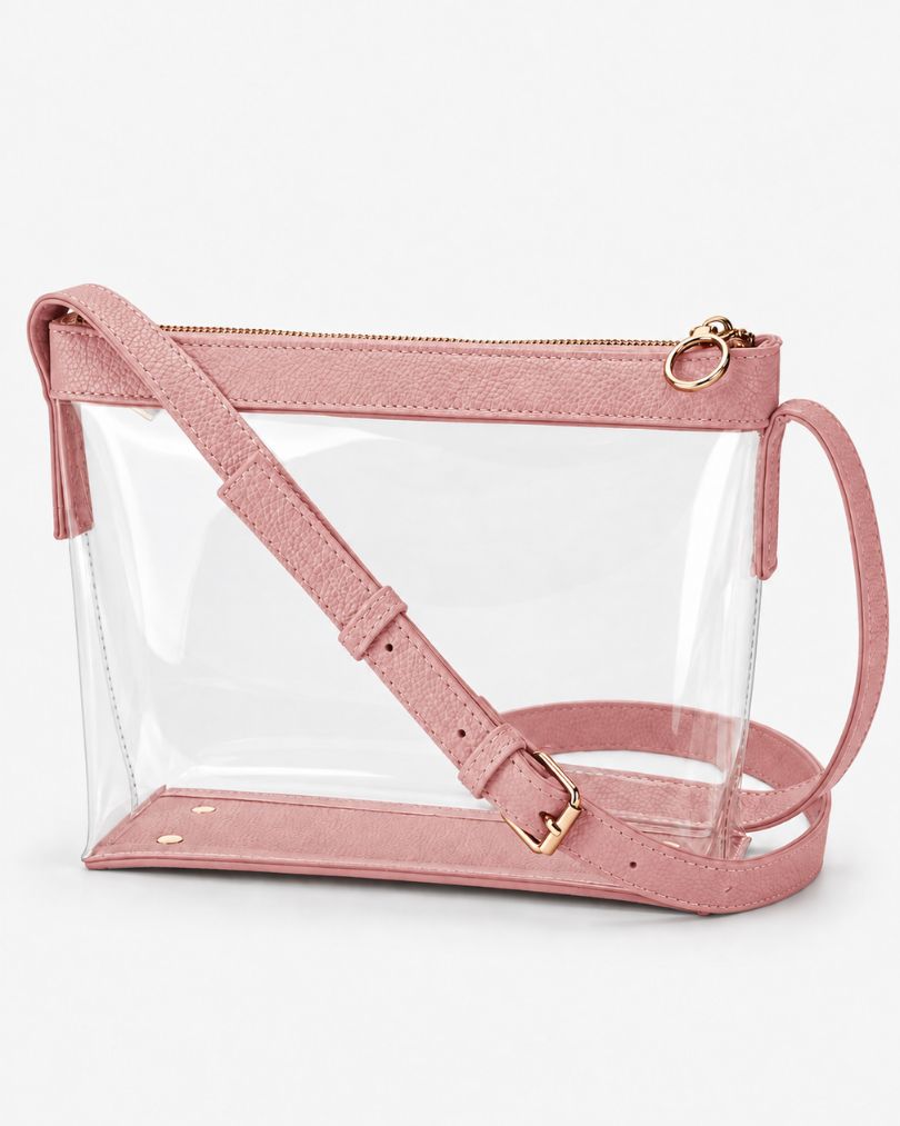 Pink clear crossbody purse with vegan leather trim, gold-tone zipper and buckle, empty, in a three-quarter view on white
